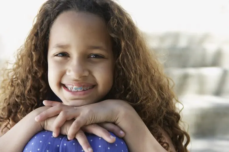 Brunette young girl smiles with her early intervention braces