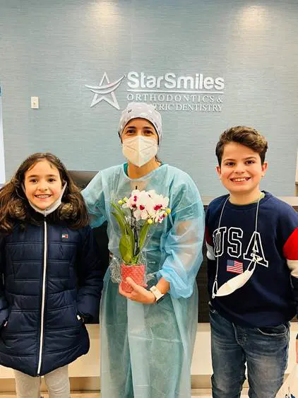 A adult and two children happy find trust children orthodontist at Star Smiles Orthodontics and Pediatric Dentistry in Bloomingdale and Naperville, IL.