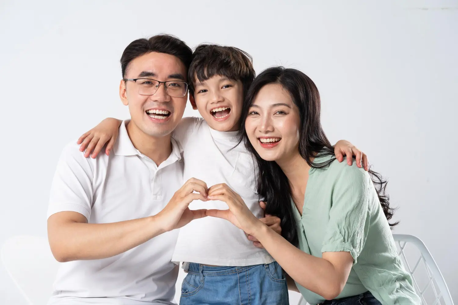 A happy family on a white background, represent Star Smiles Orthodontics and Pediatric Dentistry with orthodontic appliances modern in Bloomingdale and Naperville, IL.