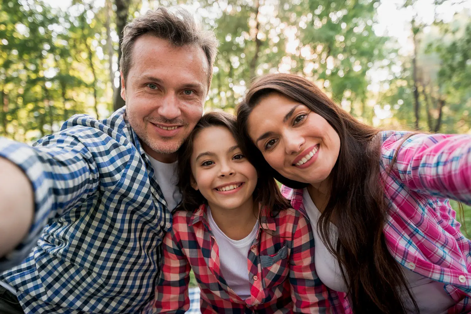 A family enjoys a selfie outdoors, proudly showing their new metal braces—thanks to Star Smiles Orthodontics and Pediatric Dentistry located in Bloomingdale and Naperville, IL.