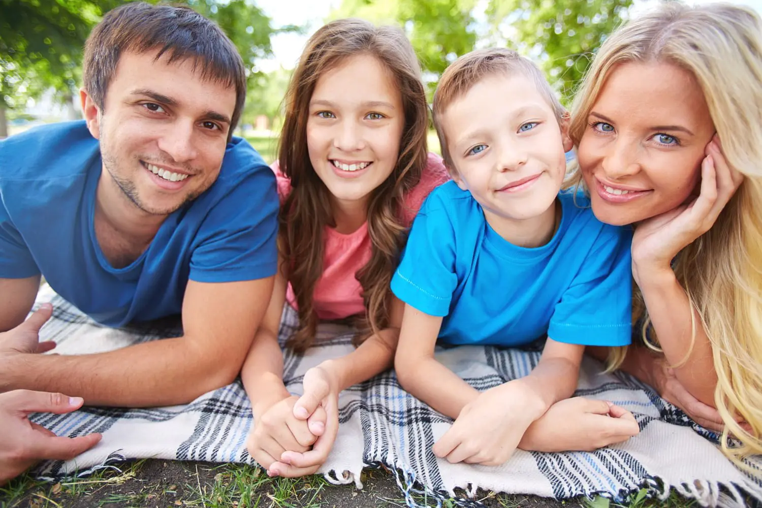 Happy family taking selfie in park, discuss about types of braces maybe choose for journey dentral braces treatment at Star Smiles Orthodontics and Pediatric Dentistry in Bloomingdale and Naperville, IL