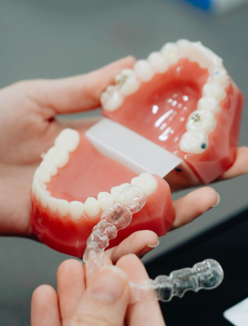 A person hold a clear dental aligners from Invisalign show easy Invisalign payment plan options in Bloomingdale and Naperville, IL.