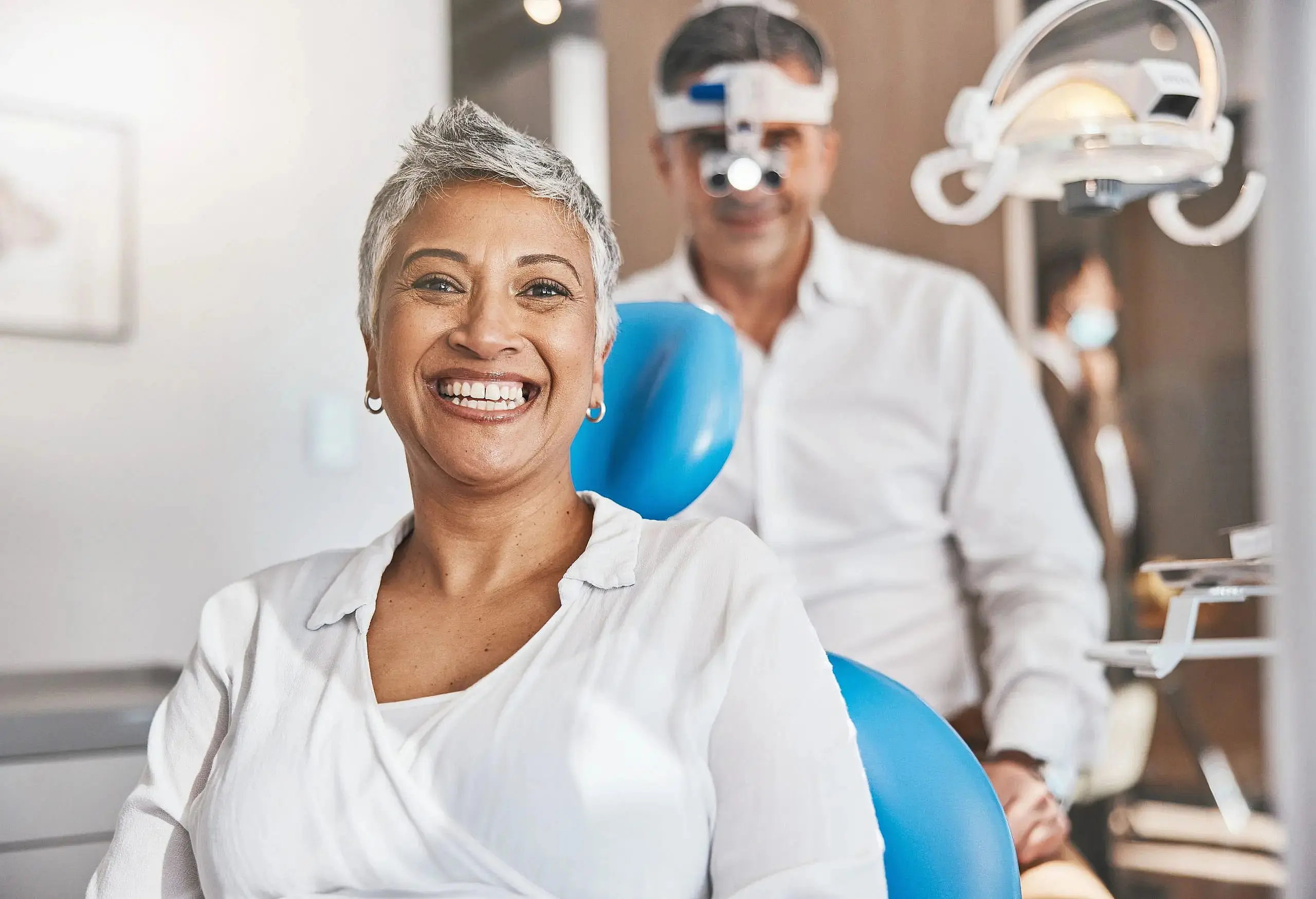 A woman is sitting in a dental chair and a dentist look at at camera during journey adult orthodontics to his patient at Star Smiles Orthodontics and Pediatric Dentistry in Bloomingdale and Naperville, IL.