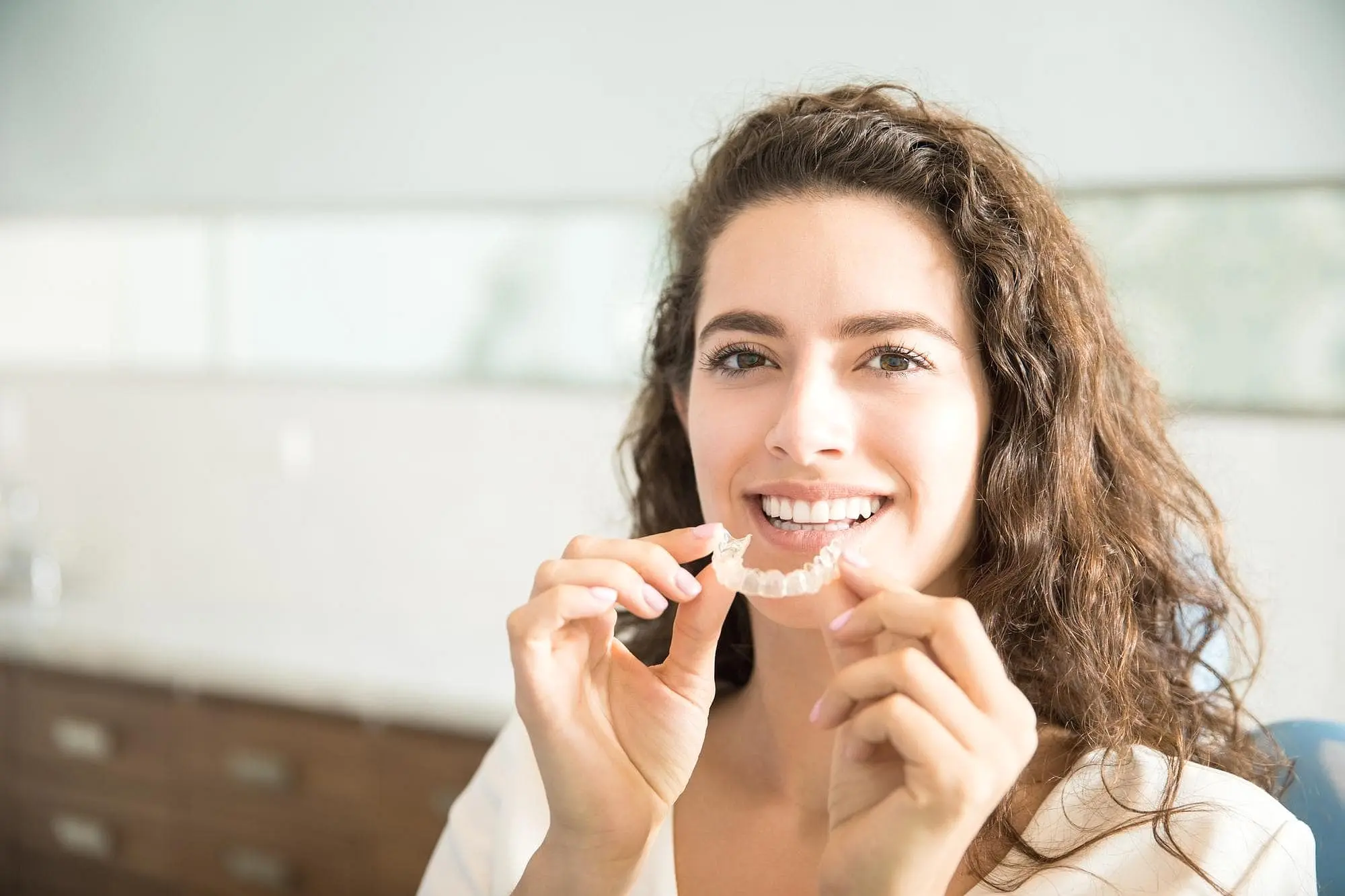 Young adult considering clear aligners treatment with a focus on convenient Invisalign payment plans in Bloomingdale and Naperville, IL.