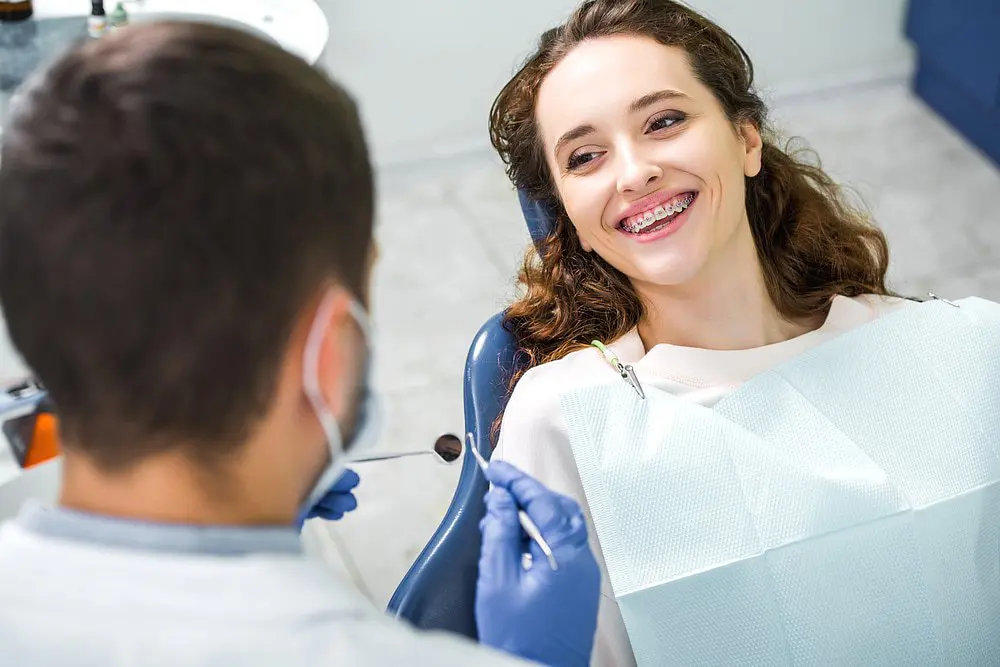 Star Smiles Orthodontics and Pediatric Dentistry Close-up of a young woman adjusting to their new braces cost during their orthodontic appointment in Bloomingdale and Naperville, IL.