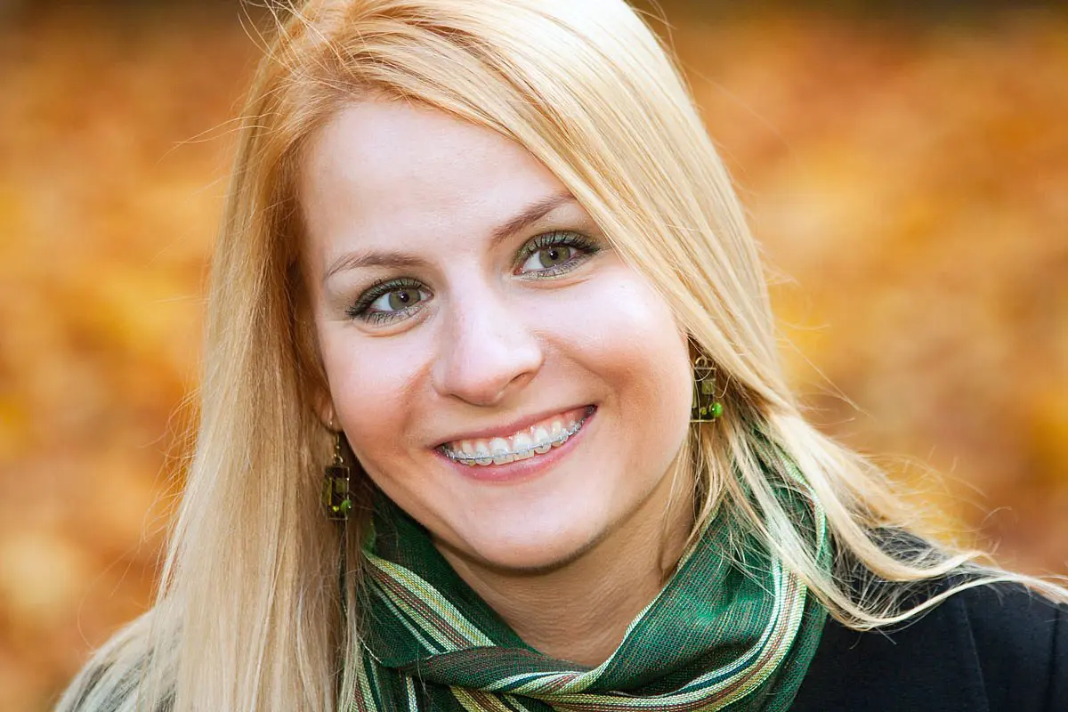 A woman smiles, after receiving expert care clear brace from a dentist at Star Smiles Orthodontics and Pediatric Dentistry in Naperville, IL.