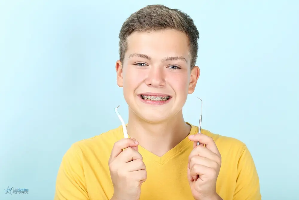 young man with metal braces toothbrush dentist tool - How to Floss with Braces in Bloomingdale and Naperville, IL 