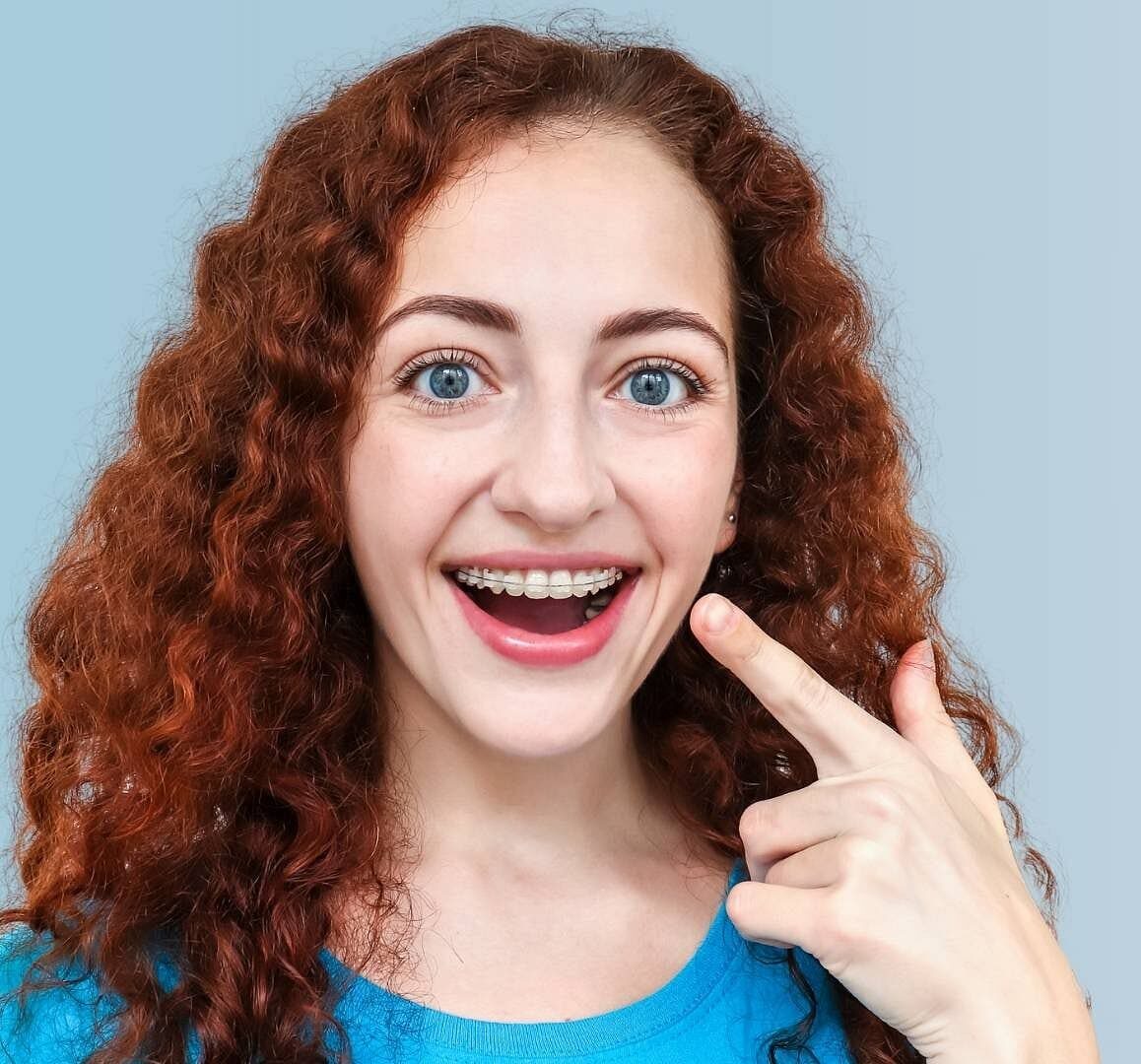 A women wearing an adult ceramic braces, smiling happily at Star Smiles Orthodontics and Pediatric Dentistry in Bloomingdale and Naperville, IL.